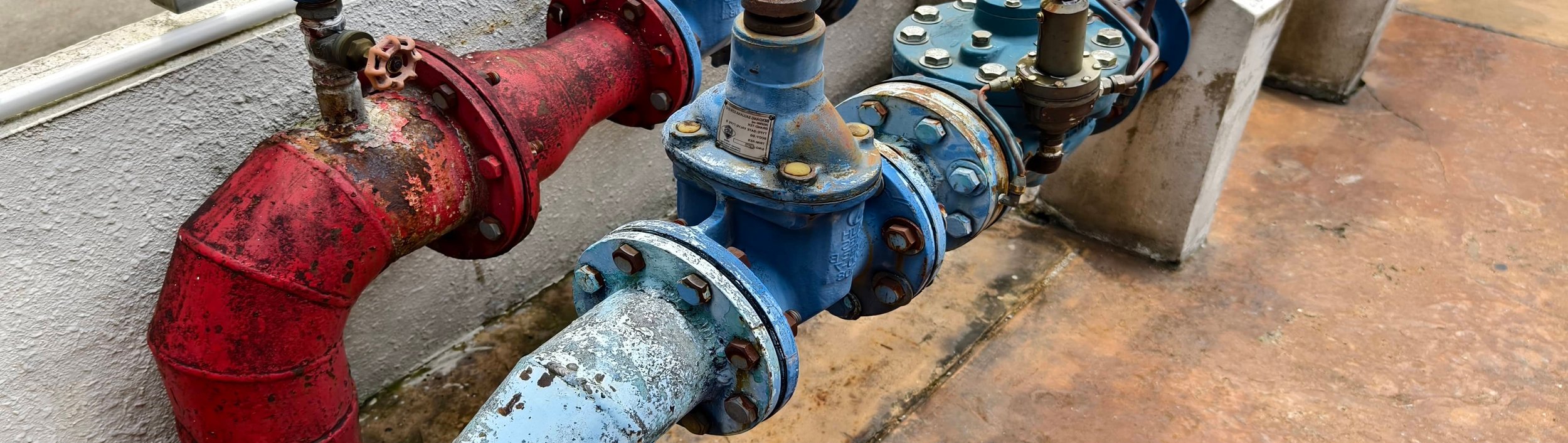Backflow valves and pipes in utility area