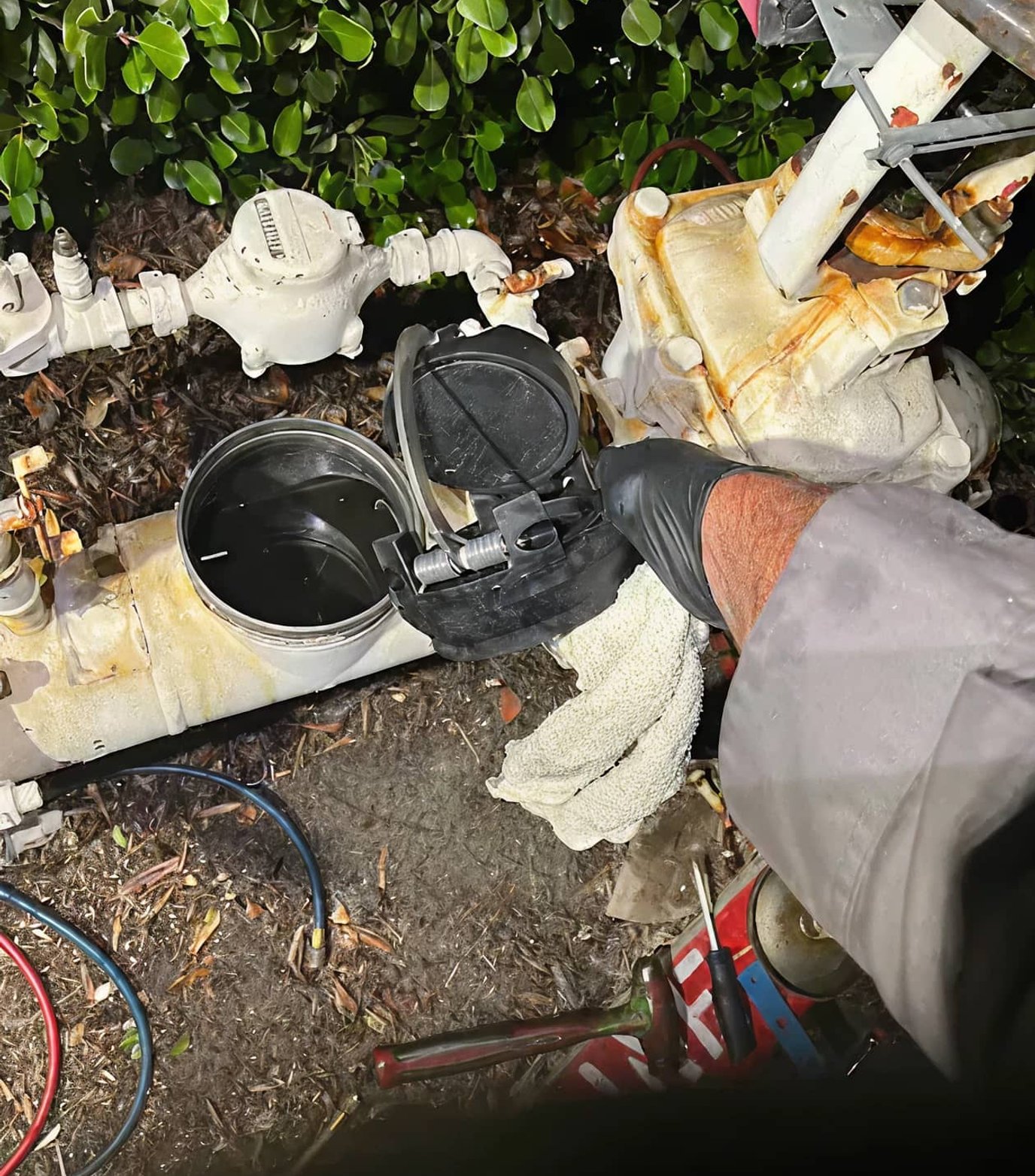 Technician repairing leaking backflow system